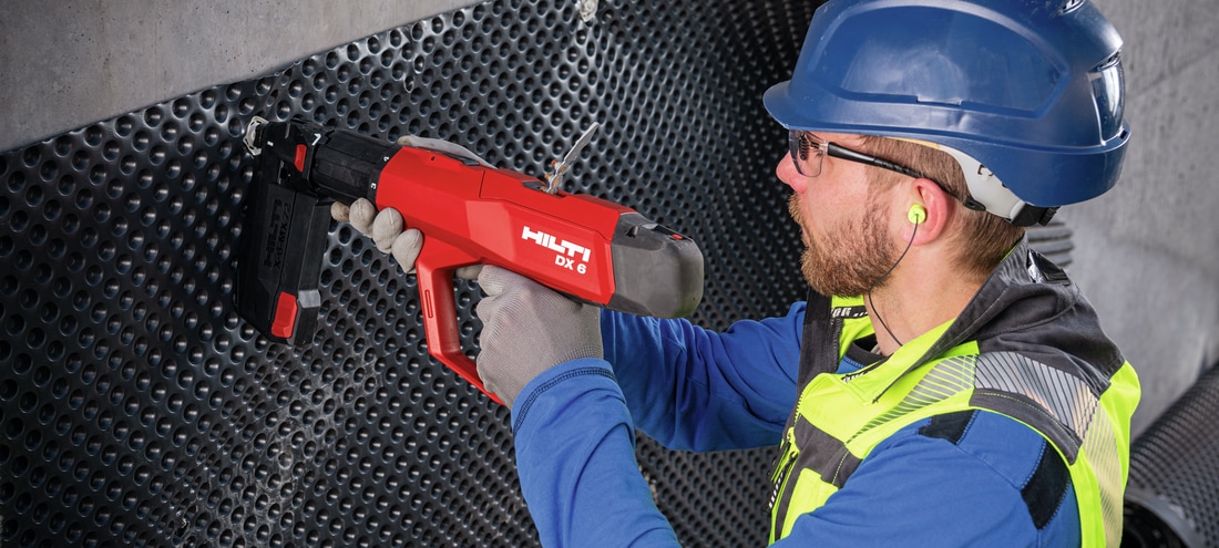 Man using the DX 6 with 10-fastener magazine