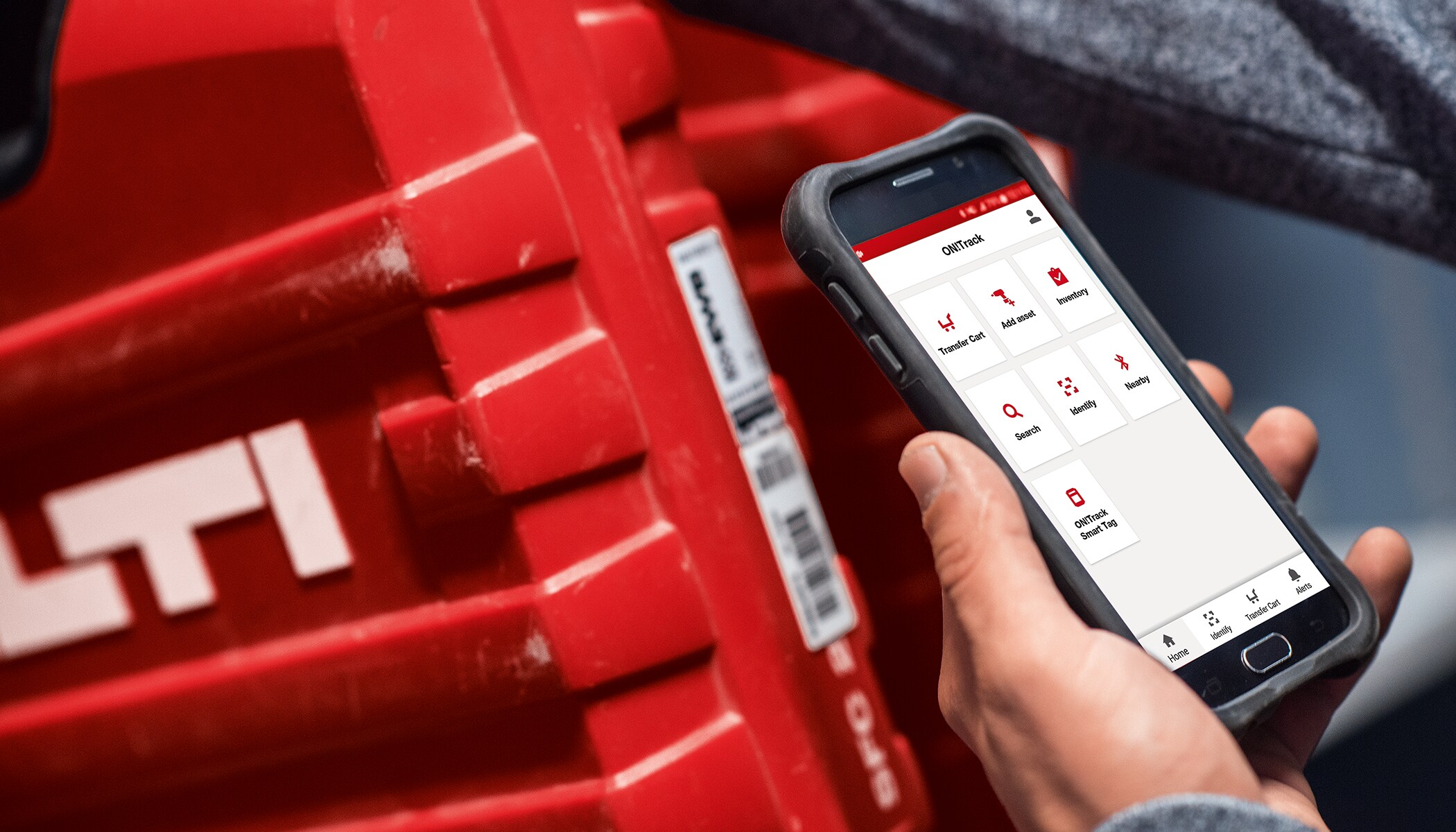 a man uses ON!Track on a mobile device to scan a hilti tool box