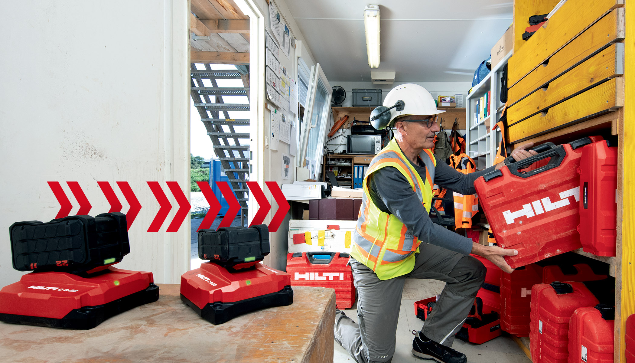 Tool Crib Manager putting away a Hilti Tool Box on a shelf in a construction container