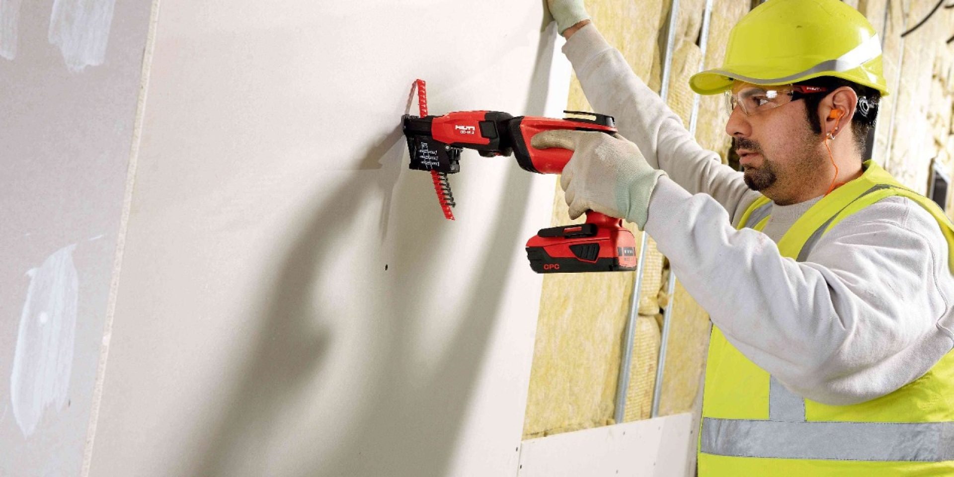 Worker using the Hilti SD M 2 to screw into drywall