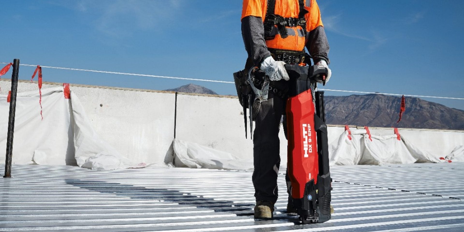 Construction worker attaching steel deck with the DX 9-ENP Powder-actuated decking tool